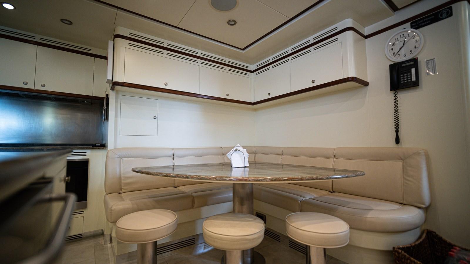 a room with a table and stools aboard ORINOKIA Yacht for Sale