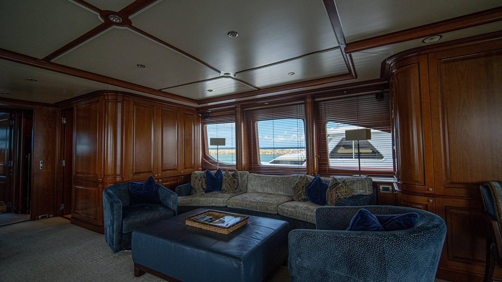 a living room with a couch and a wood cabinet aboard ORINOKIA Yacht for Sale