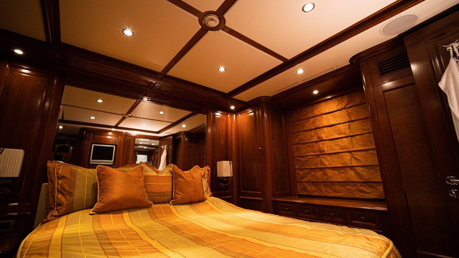 a bed with a yellow sheet aboard ORINOKIA Yacht for Sale