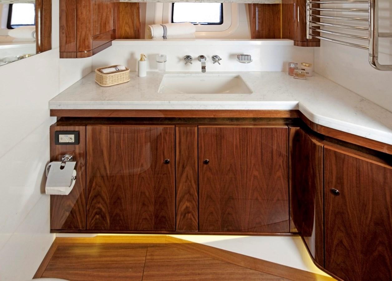 a kitchen with wooden cabinets aboard SERAFIM Yacht for Sale