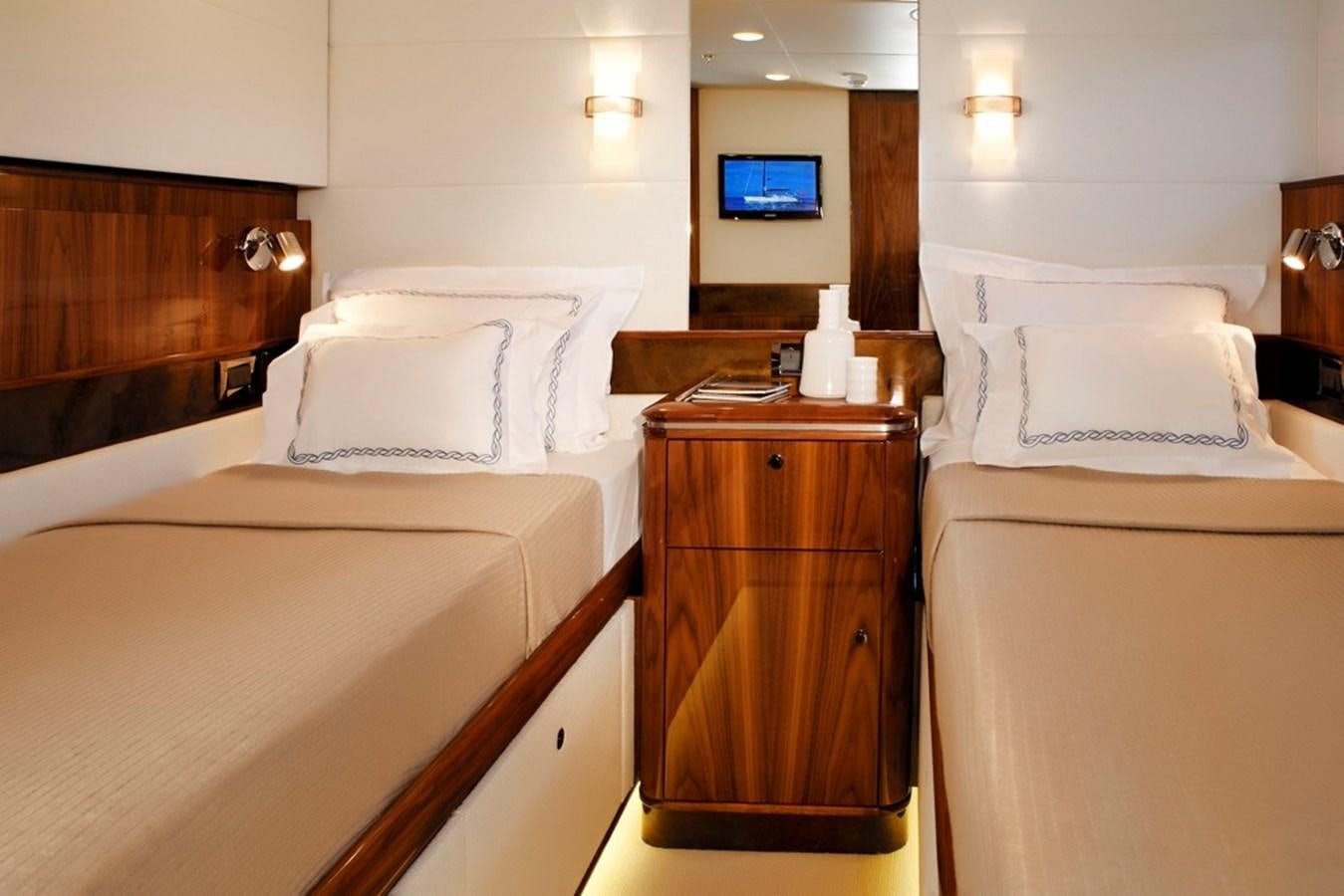 a room with a bed and a television aboard SERAFIM Yacht for Sale