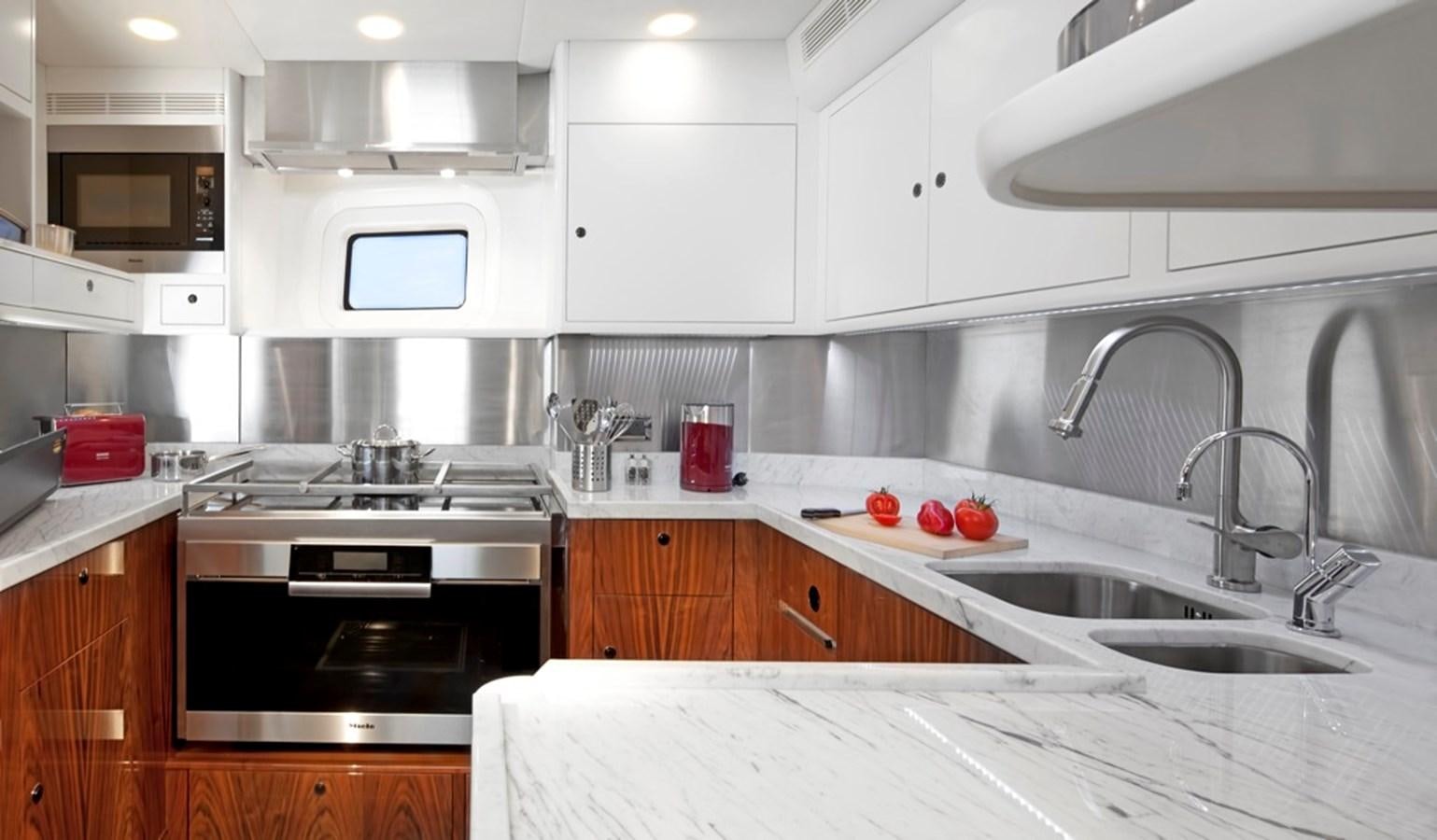 a kitchen with white cabinets aboard SERAFIM Yacht for Sale