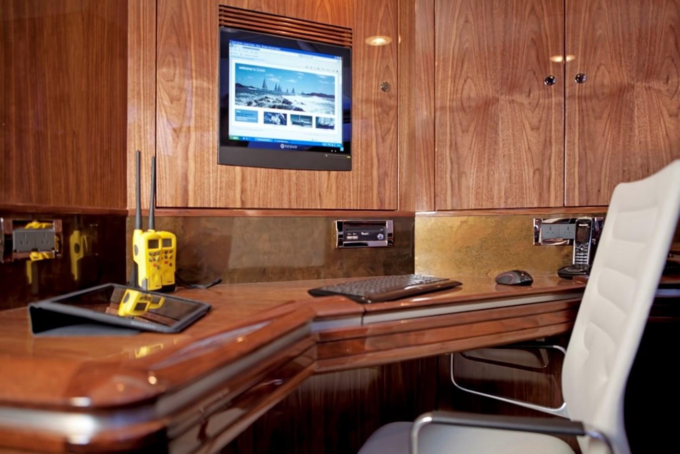 a desk with a computer and a chair aboard SERAFIM Yacht for Sale