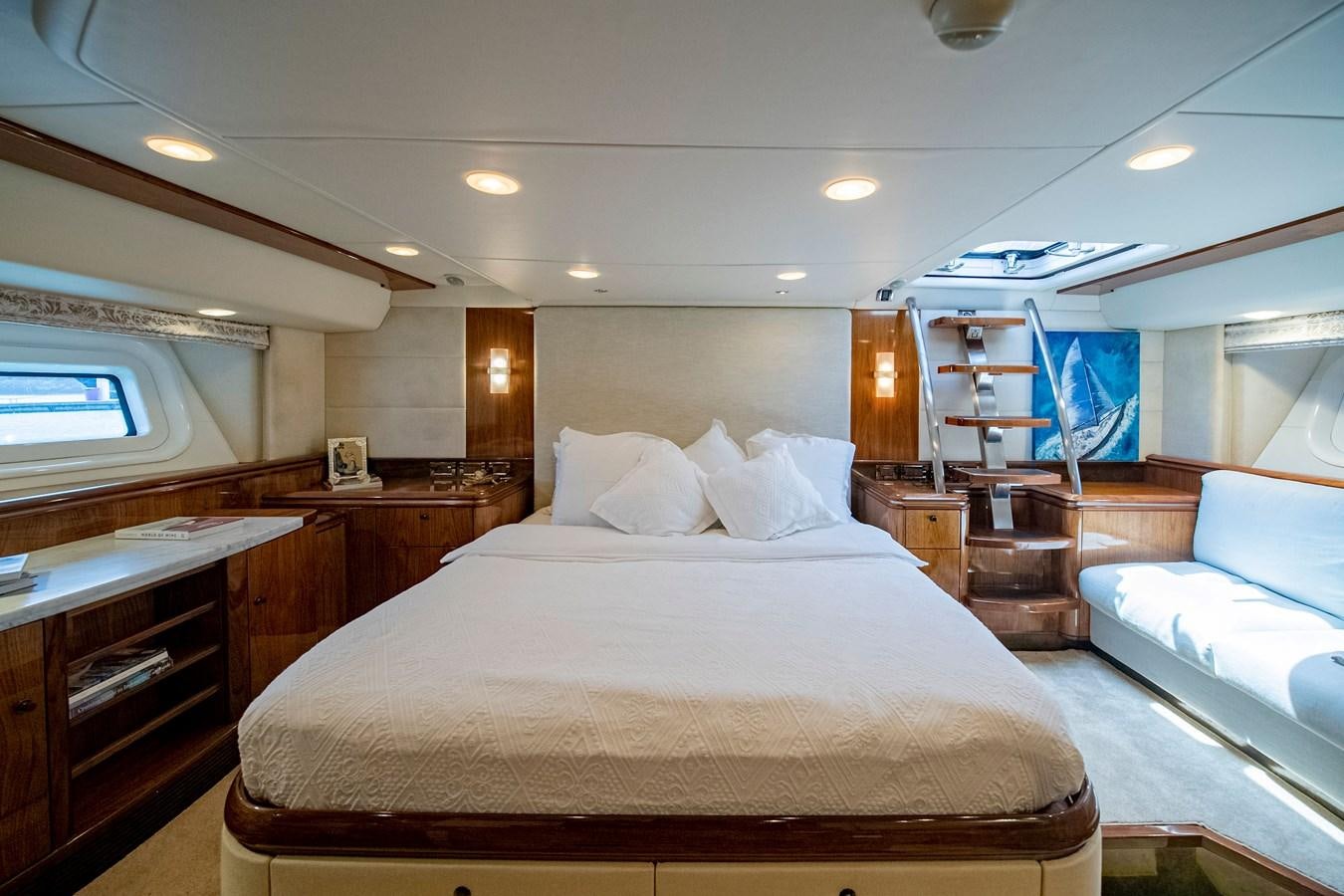 a large bedroom with a bed and a bookcase aboard SERAFIM Yacht for Sale