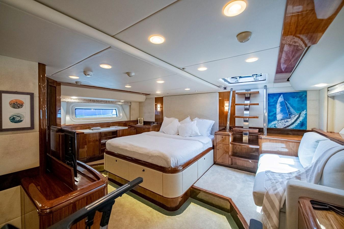 a bedroom with a bed and a desk aboard SERAFIM Yacht for Sale