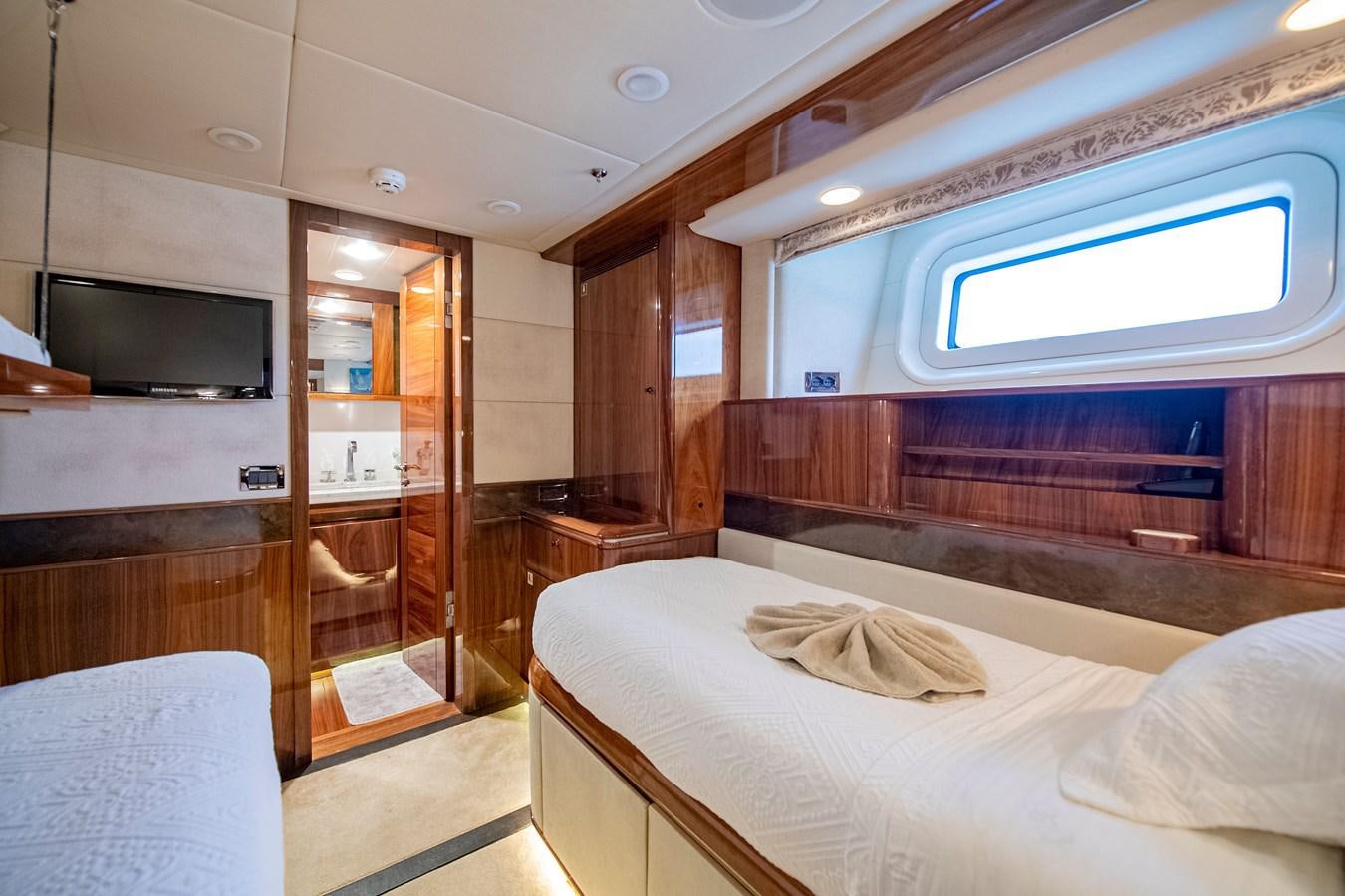 a room with a bed and a tv aboard SERAFIM Yacht for Sale