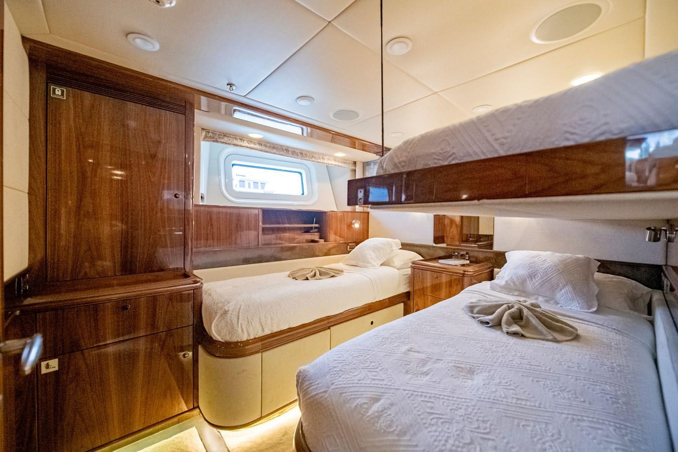 a room with a bed and a tv aboard SERAFIM Yacht for Sale