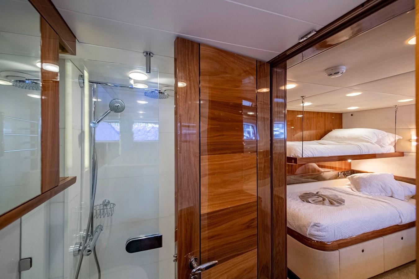 a room with a bed and a glass door aboard SERAFIM Yacht for Sale