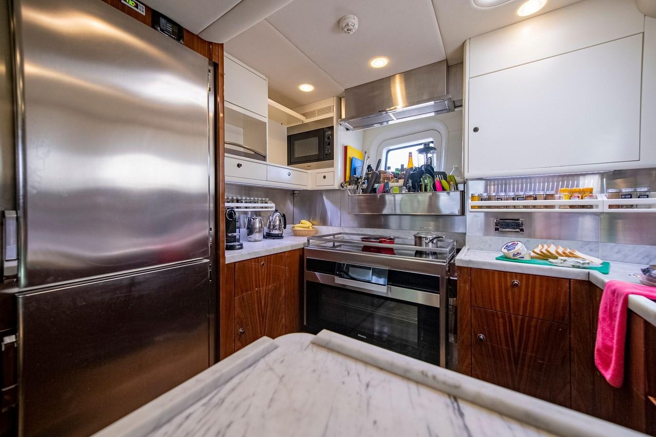 a kitchen with a fridge and oven aboard SERAFIM Yacht for Sale