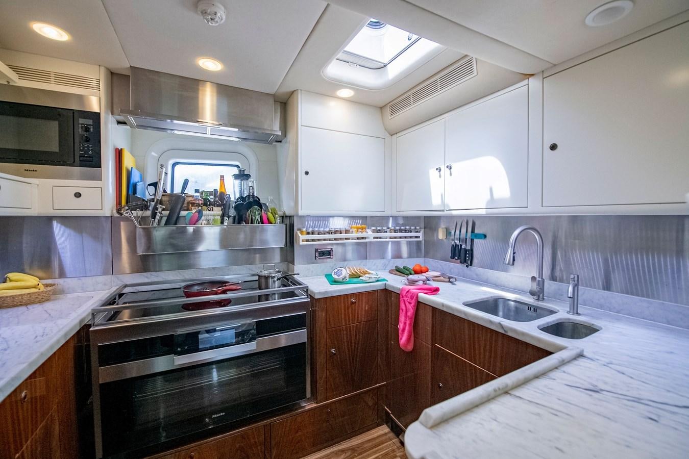 a kitchen with white cabinets aboard SERAFIM Yacht for Sale