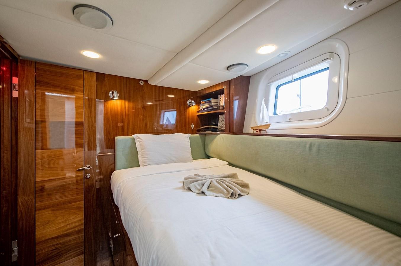 a room with a bed and a door aboard SERAFIM Yacht for Sale