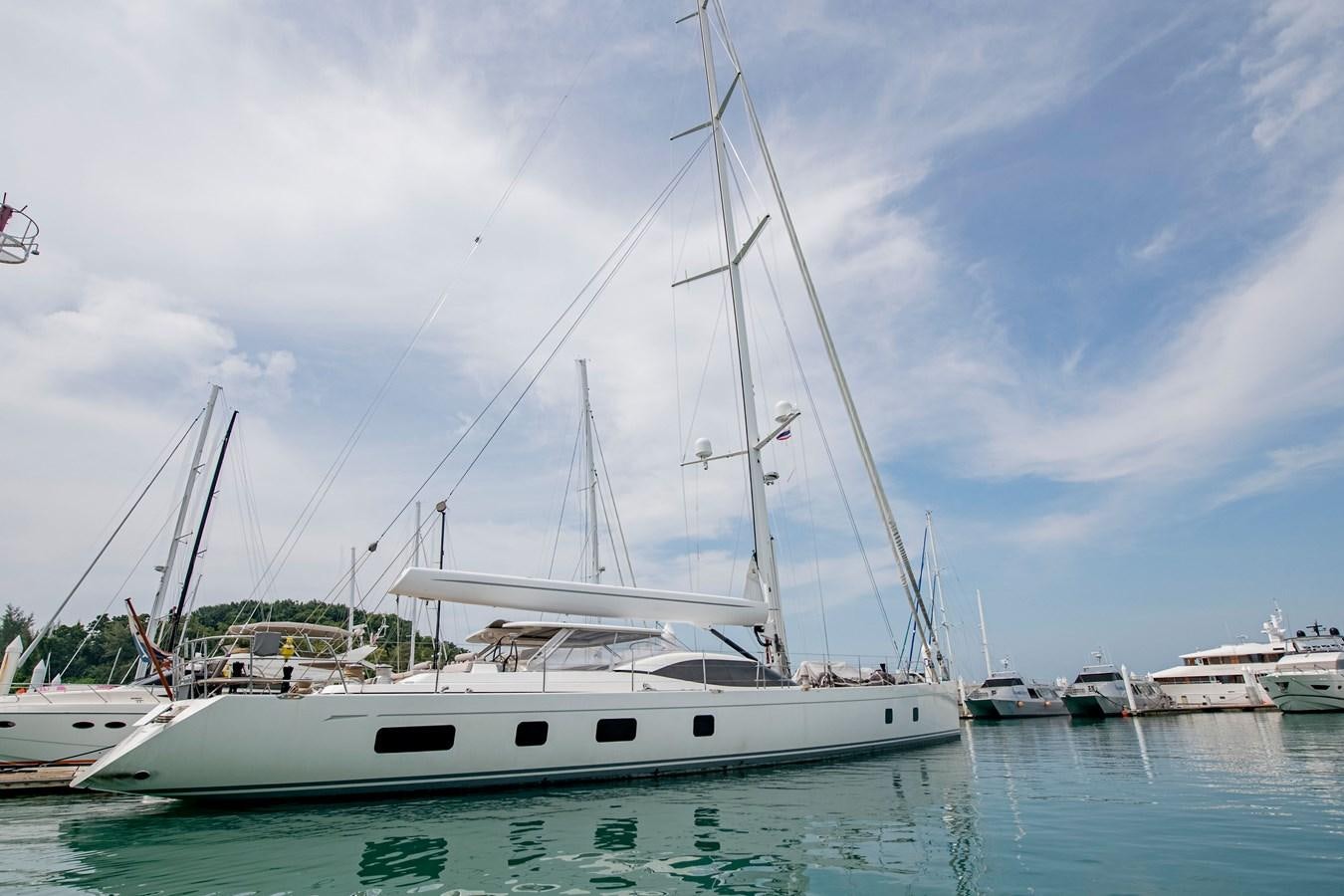 a white sailboat in a harbor aboard SERAFIM Yacht for Sale