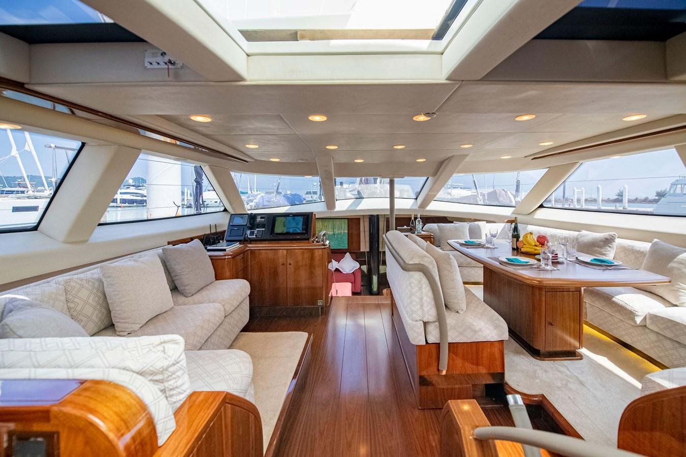a room with a couch and a table and chairs aboard SERAFIM Yacht for Sale