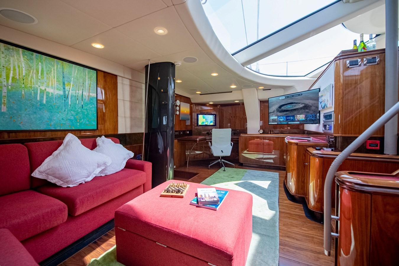 a living room with a red couch aboard SERAFIM Yacht for Sale