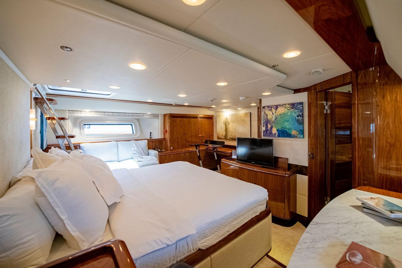 a bedroom with a bed and a television aboard SERAFIM Yacht for Sale