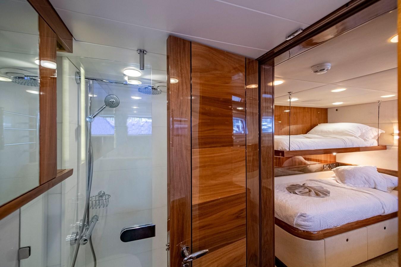 a room with a bed and a glass door aboard SERAFIM Yacht for Sale