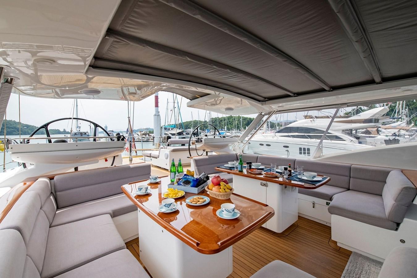 a boat with a table and chairs aboard SERAFIM Yacht for Sale