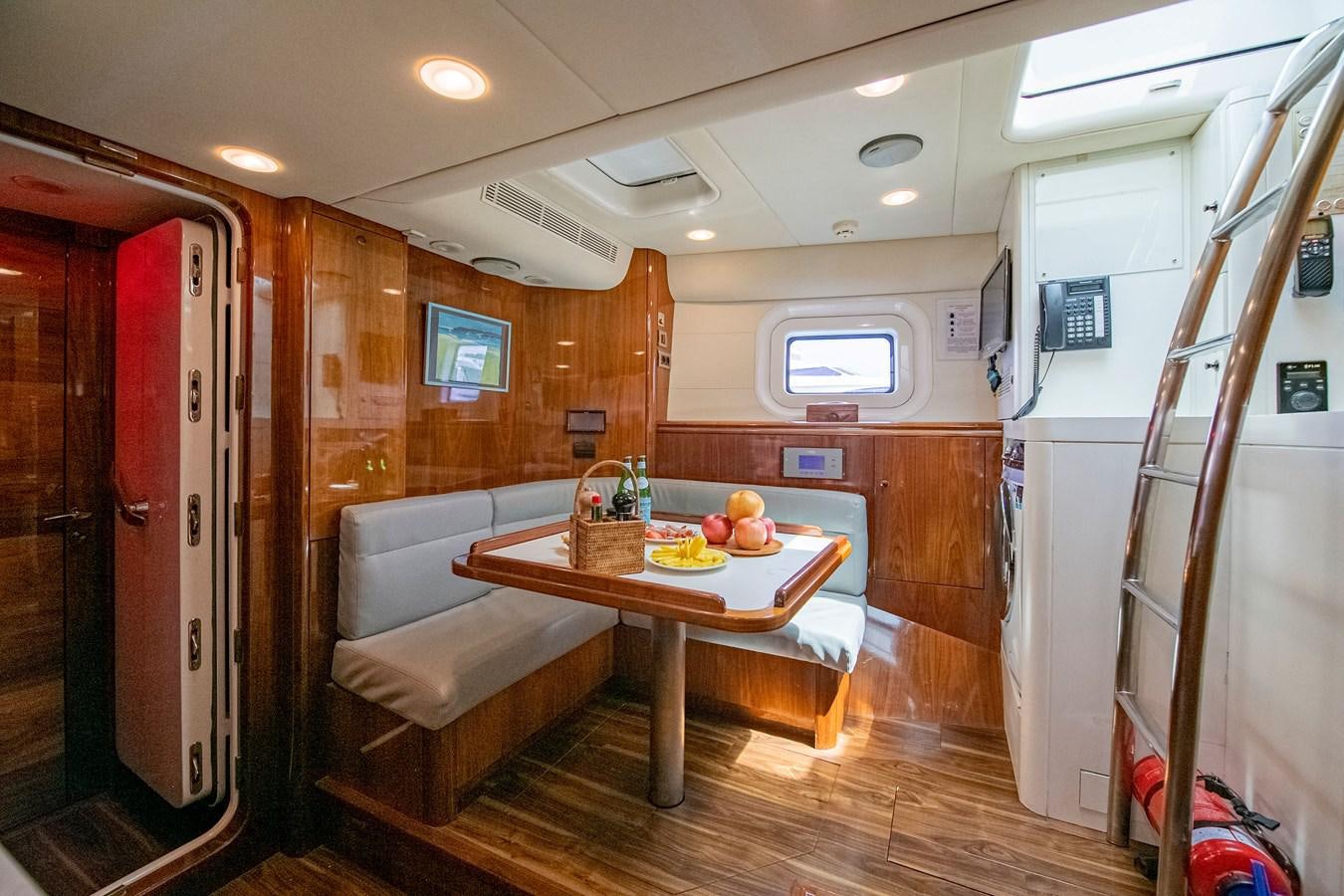 a table and couch in a room aboard SERAFIM Yacht for Sale