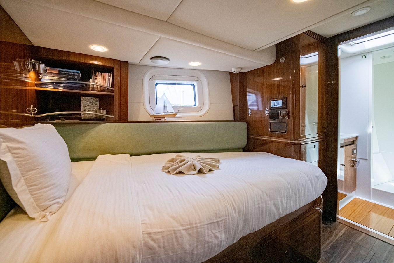 a bedroom with a bed and a desk aboard SERAFIM Yacht for Sale
