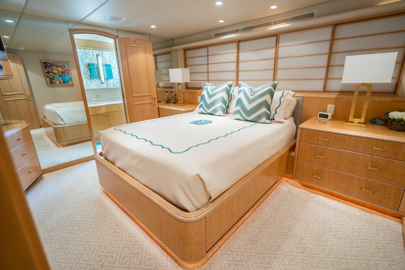 a bedroom with a bed and a desk aboard SEA DREAMS Yacht for Sale