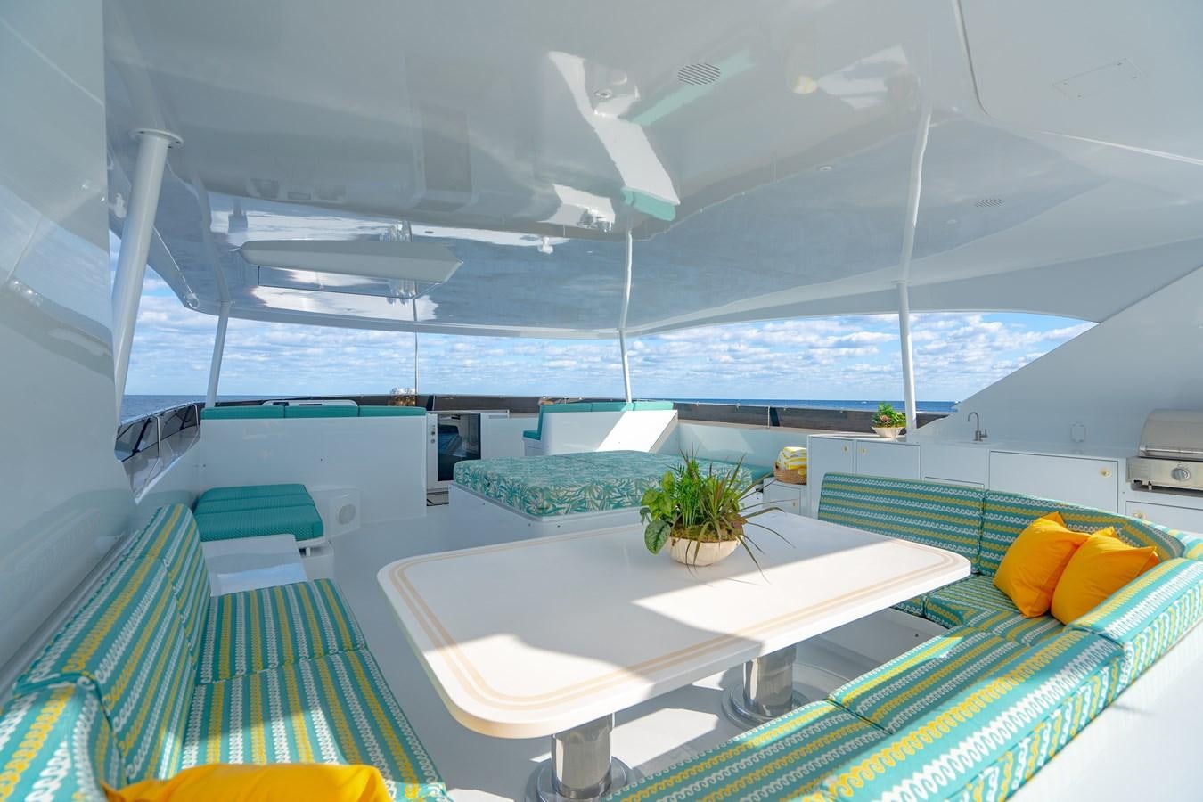 a room with a table and chairs aboard SEA DREAMS Yacht for Sale