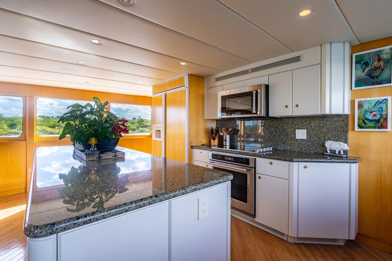 a kitchen with a glass table aboard SEA DREAMS Yacht for Sale