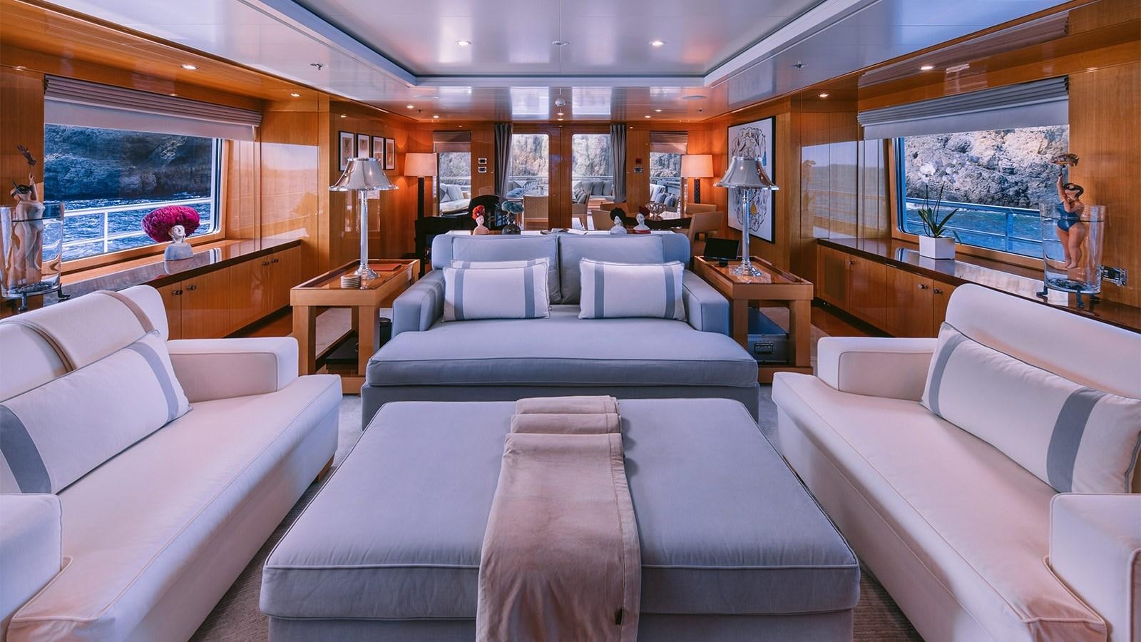 a living room with couches and a window aboard ARIELA Yacht for Sale