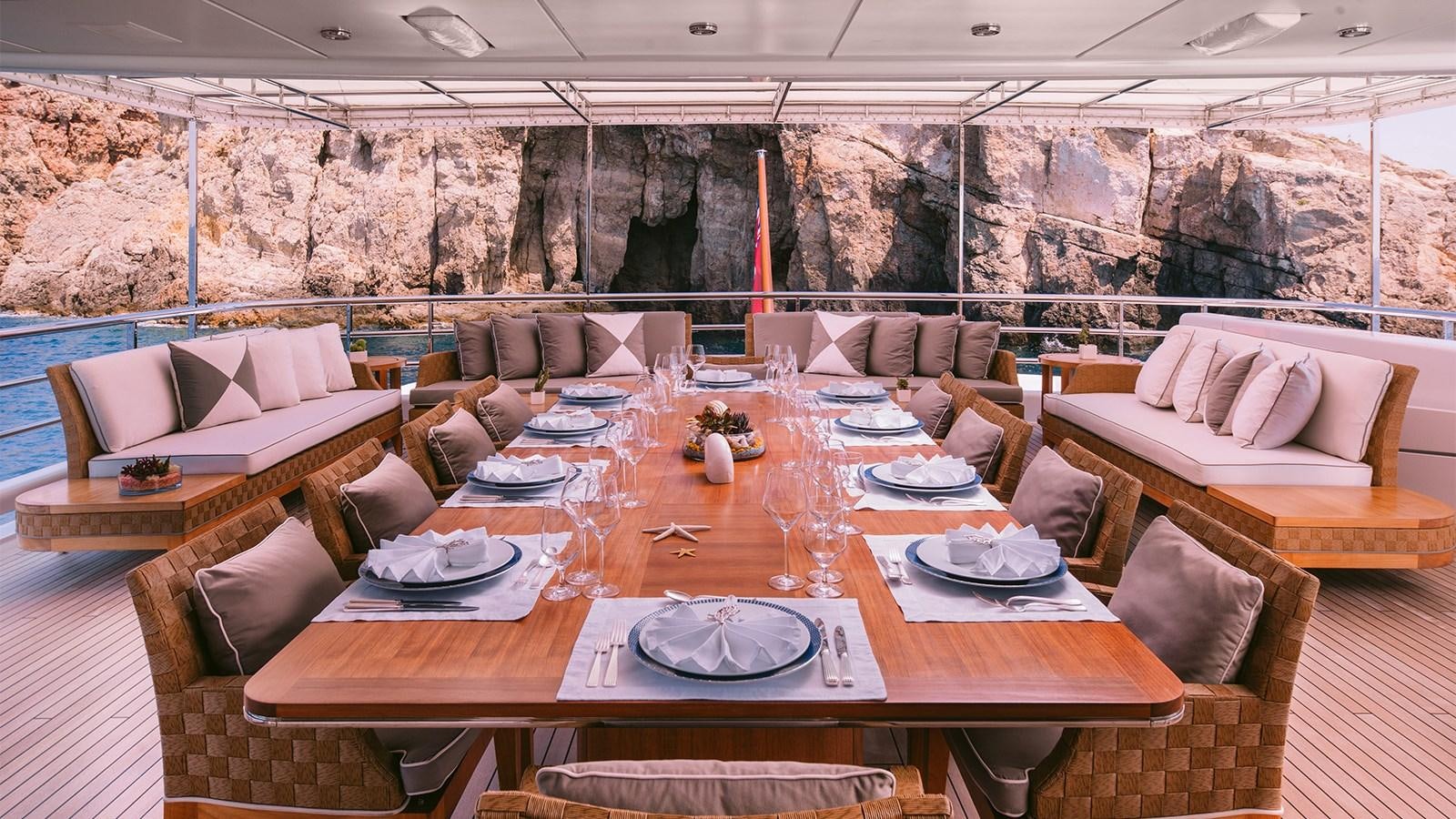 a table set with place settings aboard ARIELA Yacht for Sale