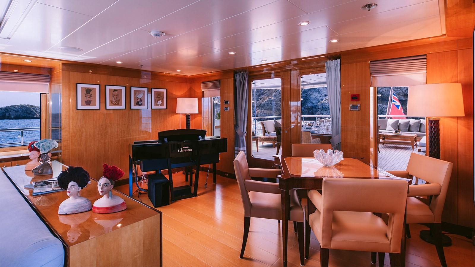a room with a table and chairs aboard ARIELA Yacht for Sale