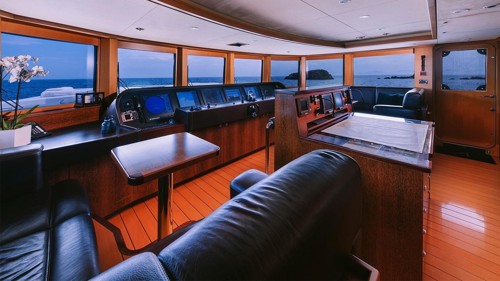 a room with a table and chairs aboard ARIELA Yacht for Sale