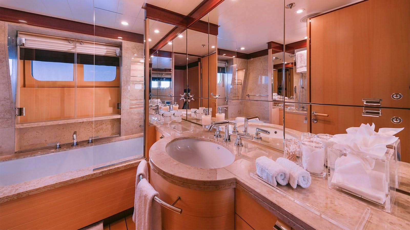 a bathroom with a large mirror aboard ARIELA Yacht for Sale