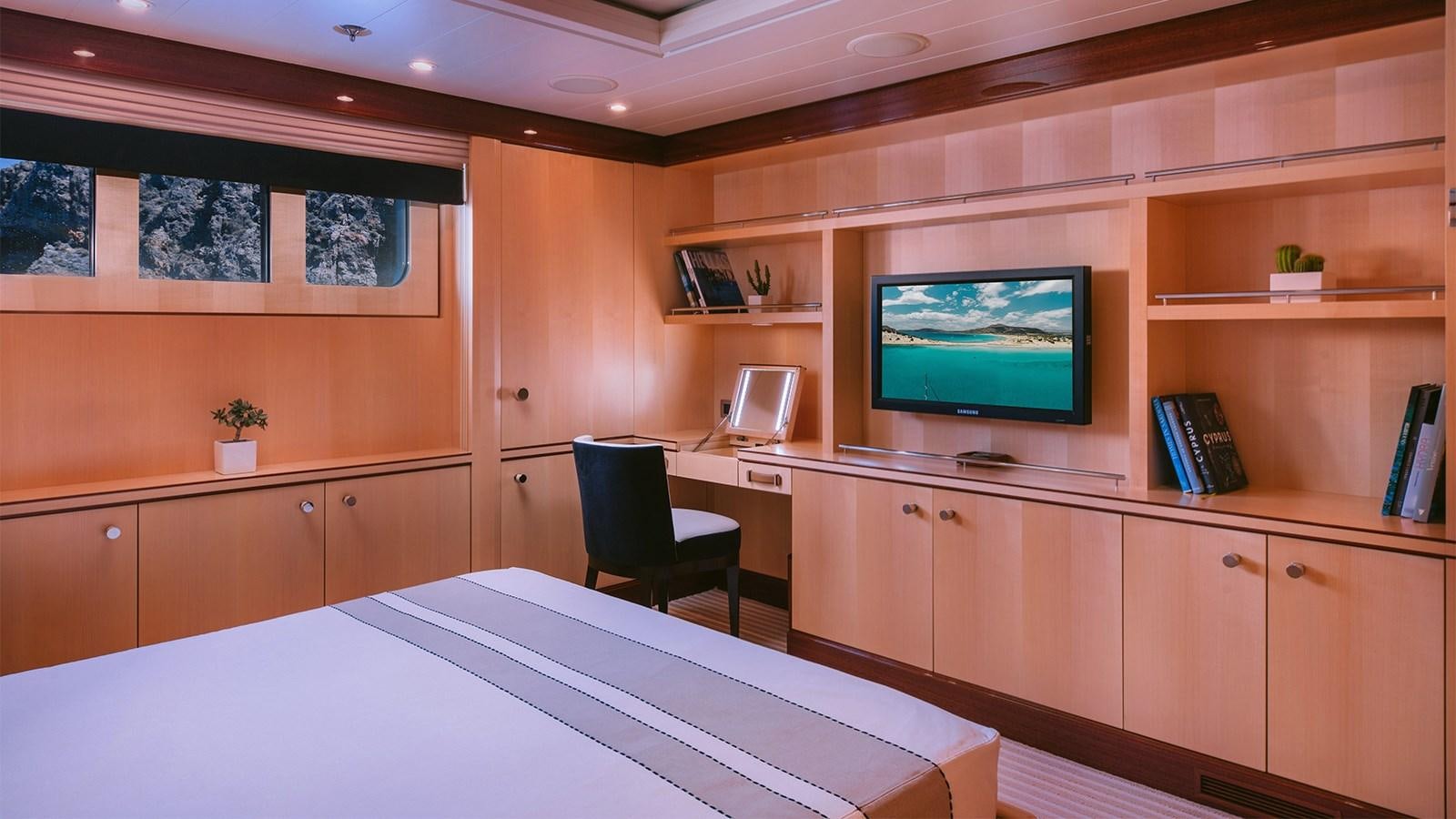 a room with a tv and a desk aboard ARIELA Yacht for Sale