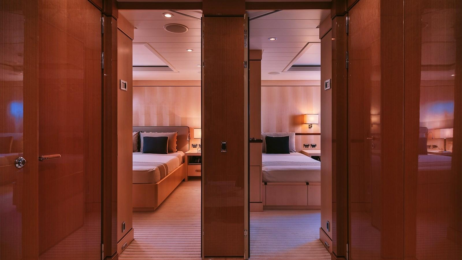 a room with a bed and a door aboard ARIELA Yacht for Sale