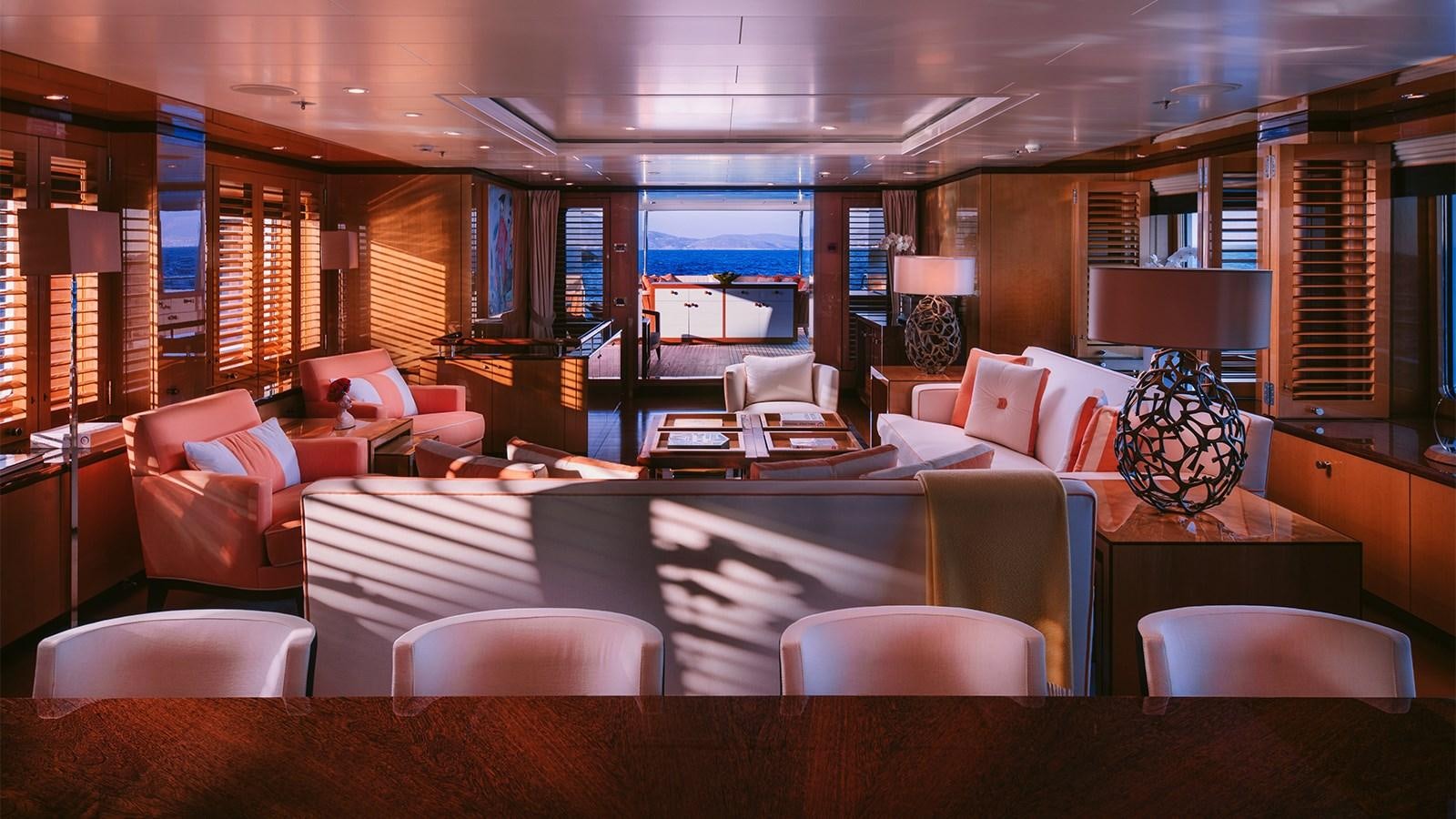 a room with a couch and a table and chairs aboard ARIELA Yacht for Sale