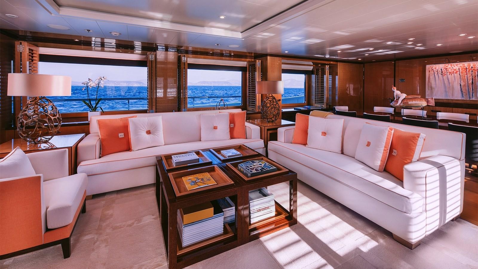 a living room with a couch and a coffee table aboard ARIELA Yacht for Sale
