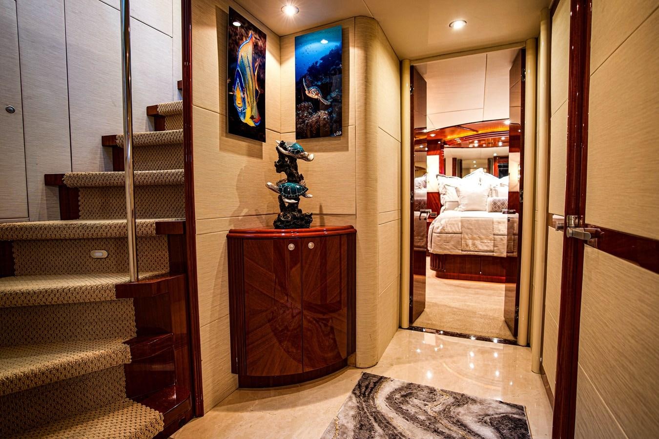 a room with a wood cabinet and a shelf with books on it aboard NEW HORIZON Yacht for Sale