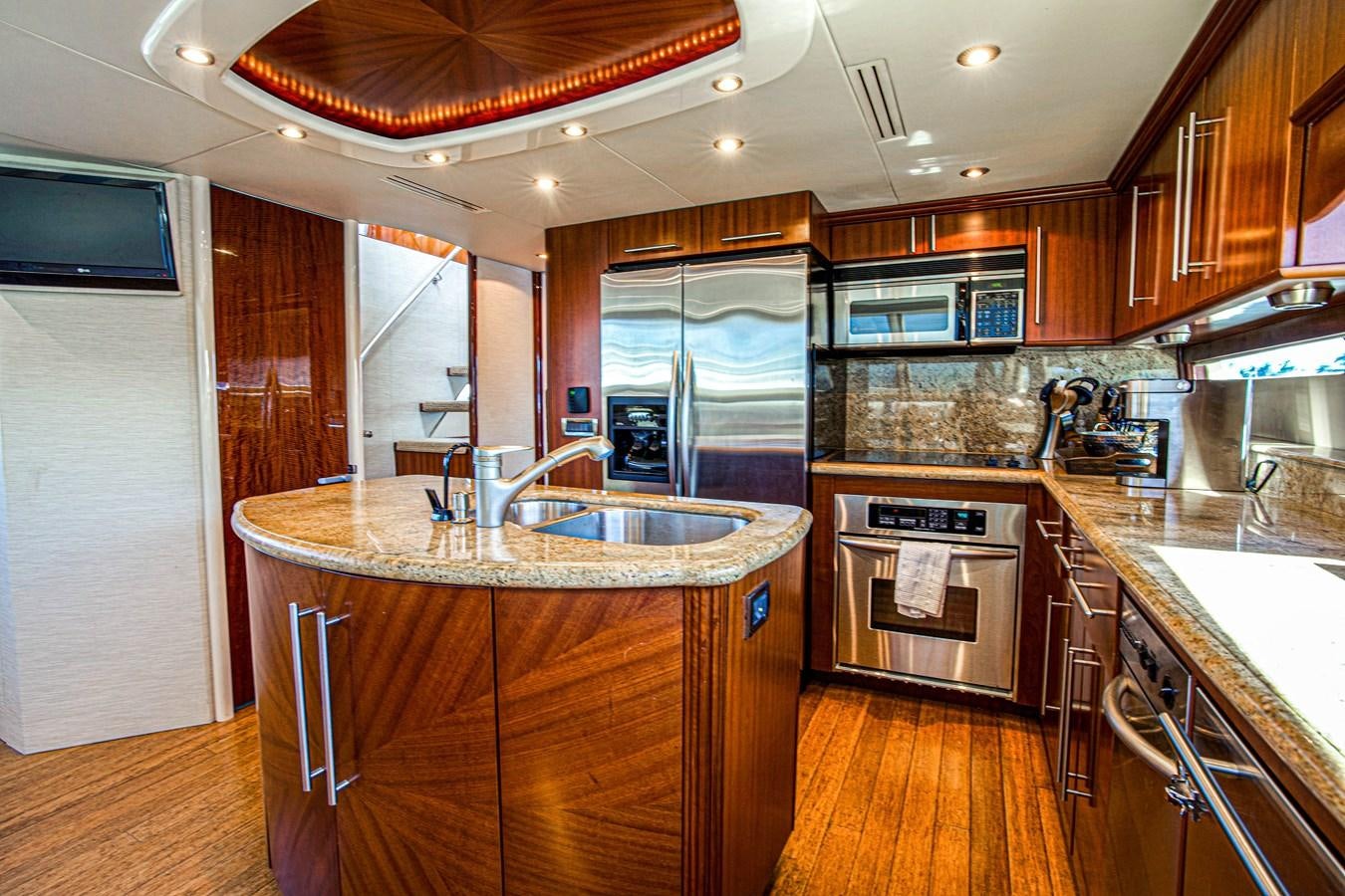a kitchen with wooden cabinets aboard NEW HORIZON Yacht for Sale