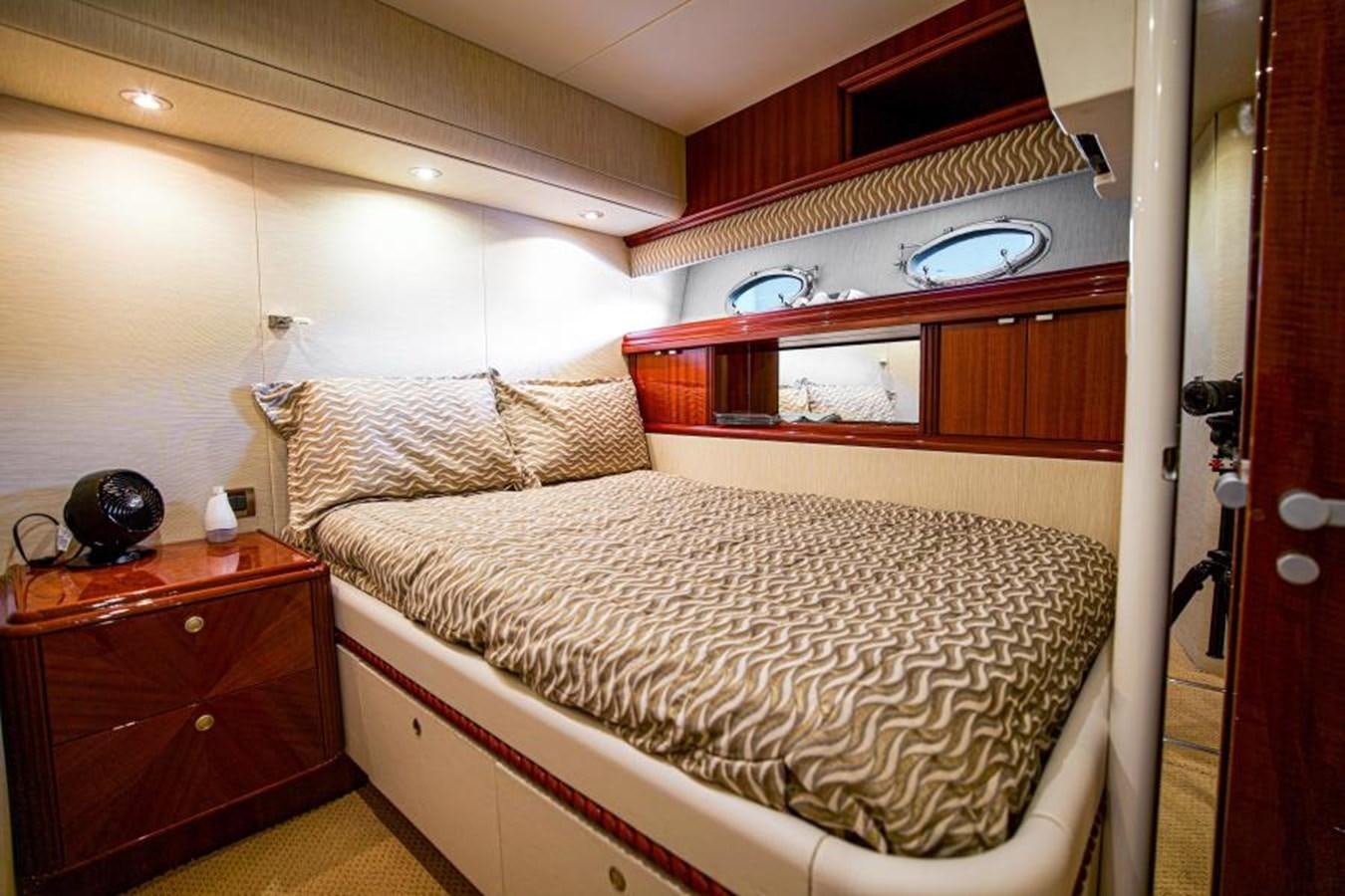 a bedroom with a bed and a dresser aboard NEW HORIZON Yacht for Sale