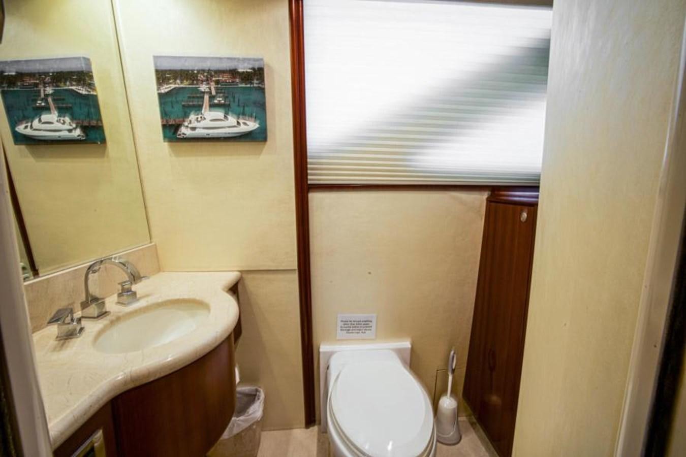 a bathroom with a sink toilet and a mirror aboard NEW HORIZON Yacht for Sale