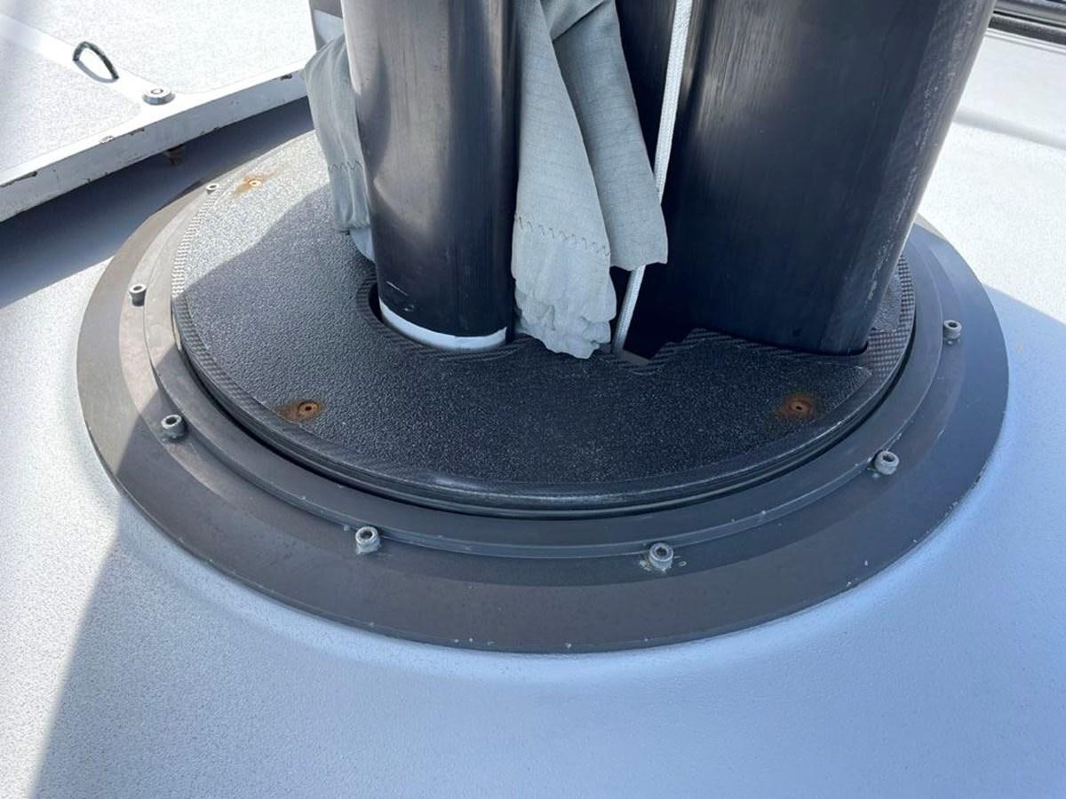 a white gloved hand holding a black object with a white substance on it aboard BLACK JACK IV Yacht for Sale