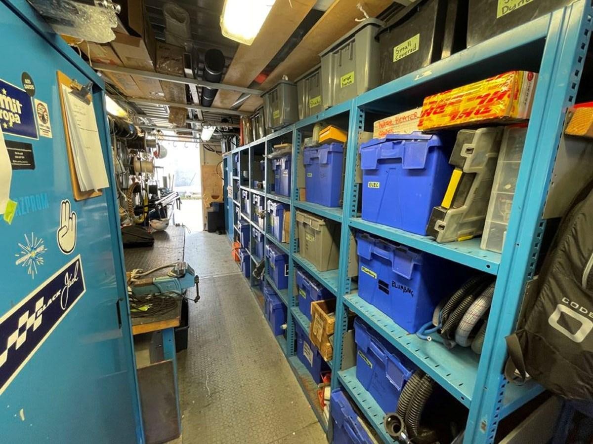 a room with shelves and blue walls aboard BLACK JACK IV Yacht for Sale