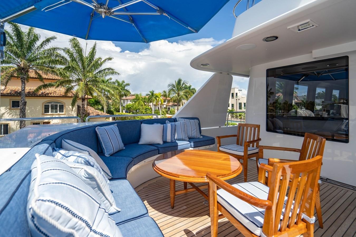a patio with a couch and chairs aboard YOLO Yacht for Sale