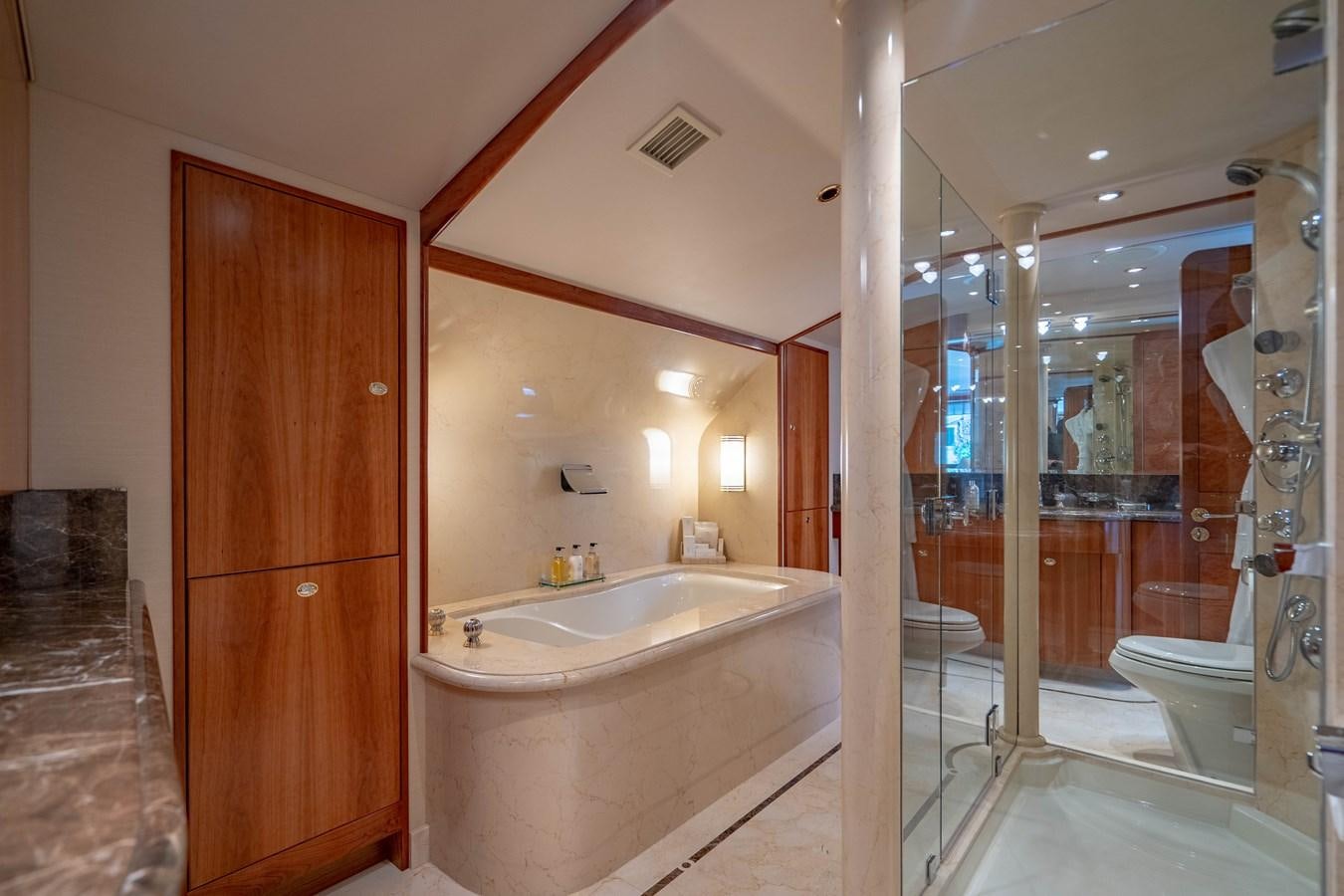 a bathroom with a bathtub and shower aboard YOLO Yacht for Sale