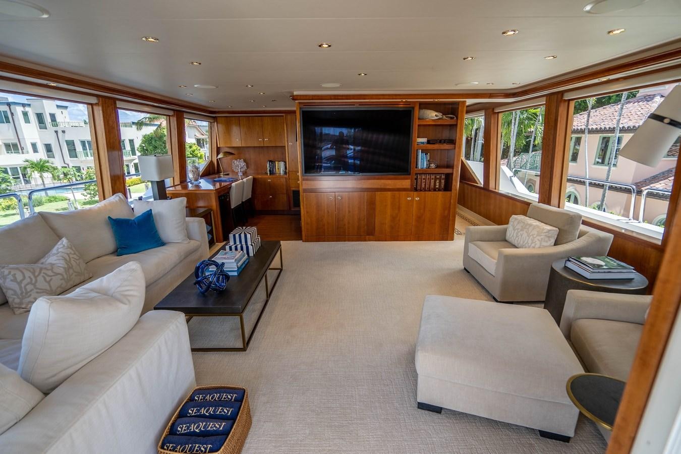 a living room with a fireplace aboard YOLO Yacht for Sale