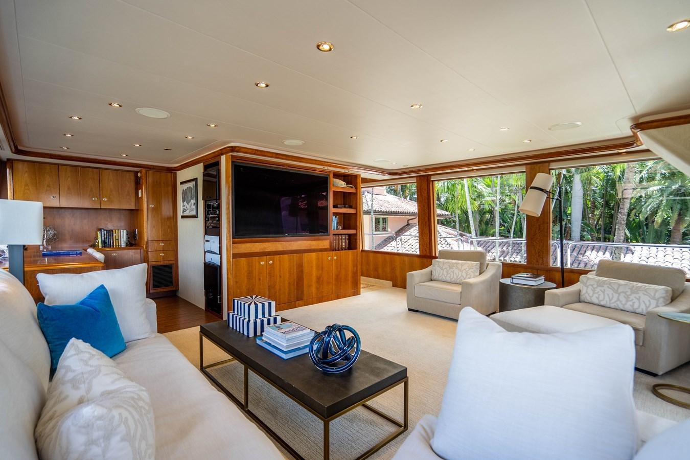 a living room with a large tv aboard YOLO Yacht for Sale