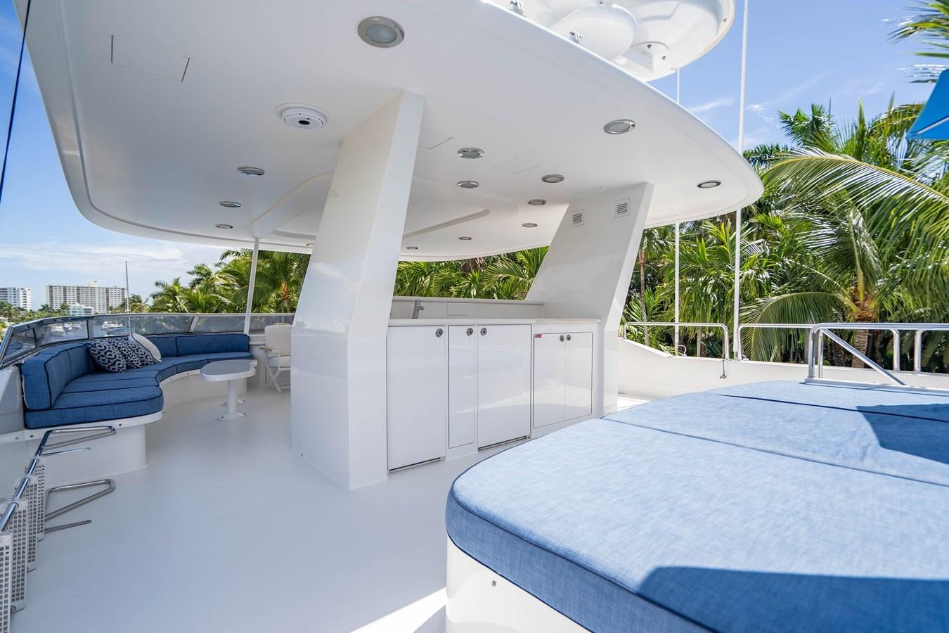 a room with a pool and a table and chairs aboard YOLO Yacht for Sale