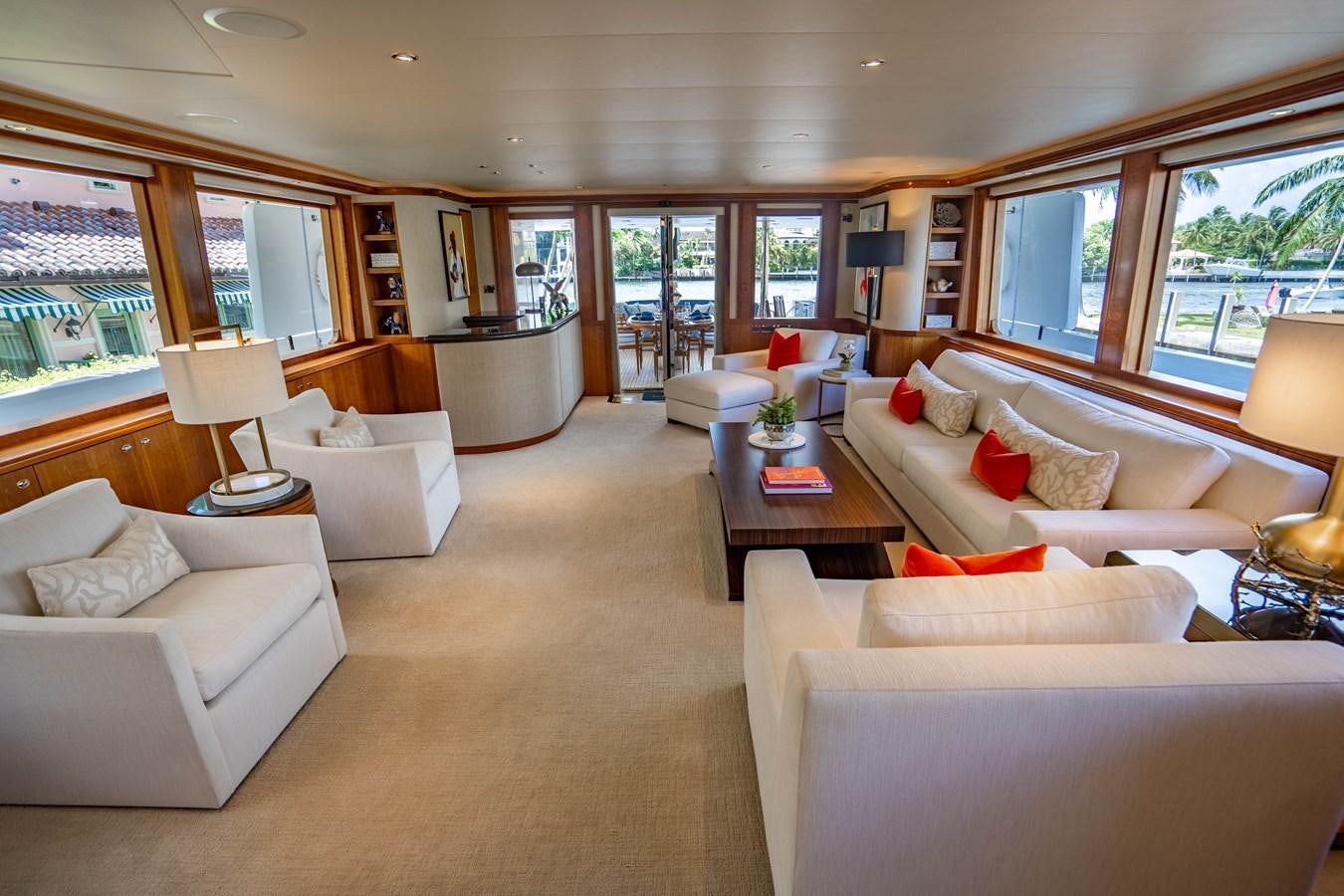 a living room with a couch and a table aboard YOLO Yacht for Sale