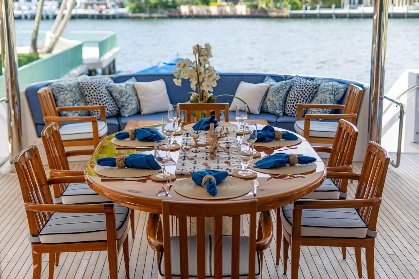 a table set for a dinner on a boat aboard YOLO Yacht for Sale