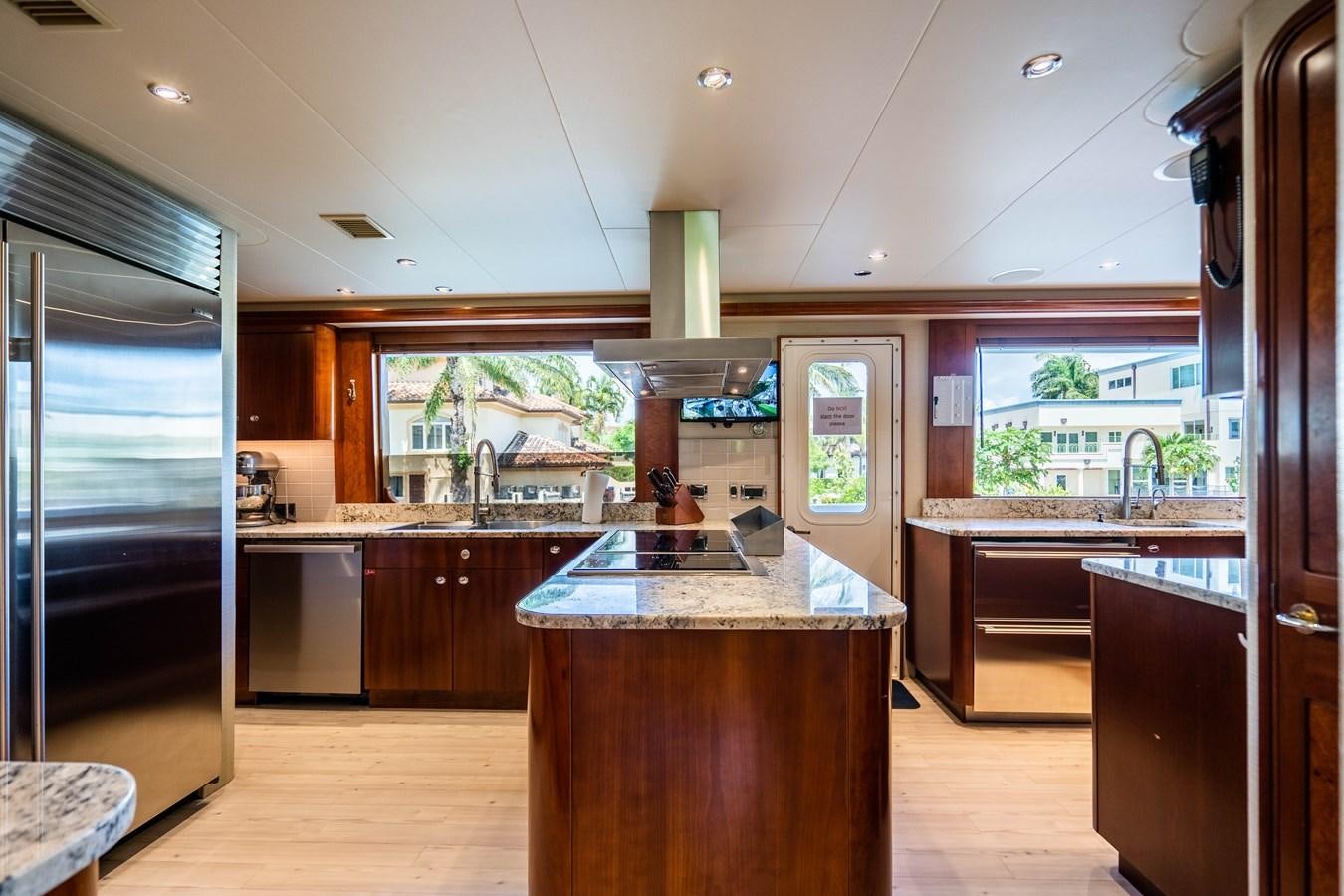 a kitchen with a large island aboard YOLO Yacht for Sale