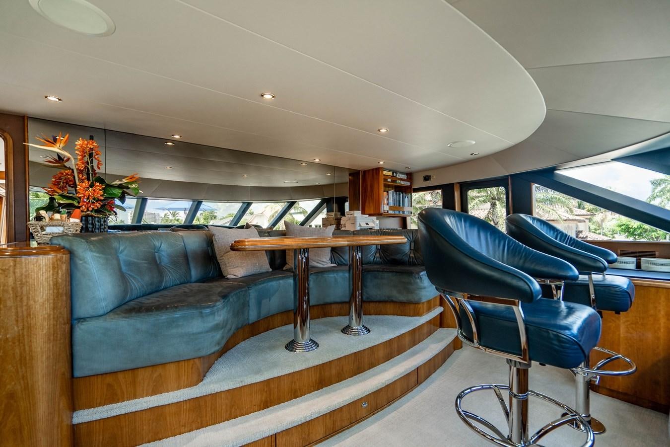 a living room with a couch and a coffee table aboard YOLO Yacht for Sale